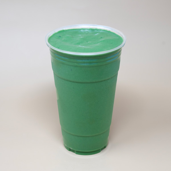 Avo Kale Smoothie in 24 oz togo cup. Coconut milk, avocado, kale, pineapple, spirulina.