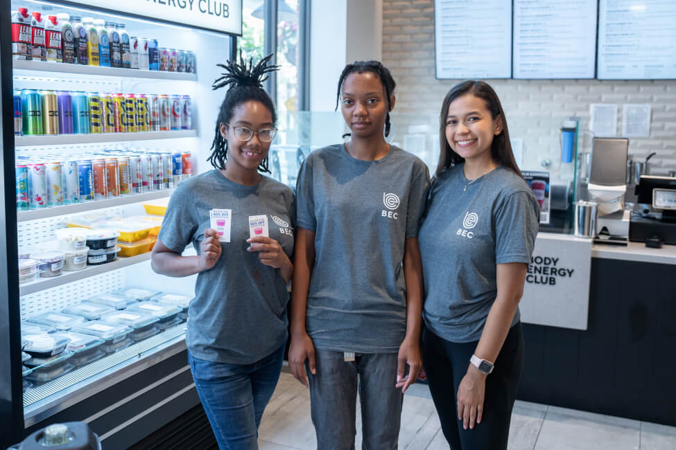Body Energy Team Lincoln Common - holding up 50% Off Smoothie cards