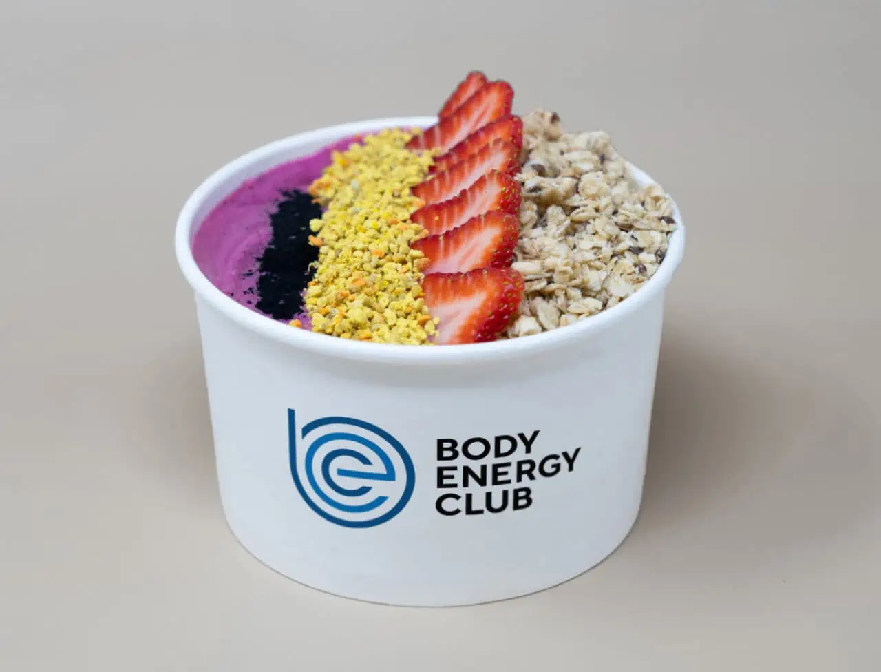 Our Strawberry Acai Bowl in a white paper bowl
