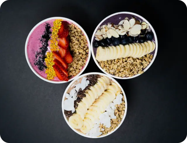 A dragon bowl, blueberry acai bowl, and a chocobliss bowl together.