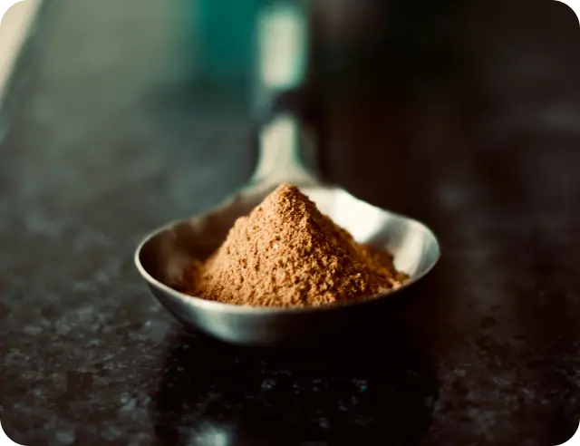 Acai Bowl addon Cocoa powder in a measuring bowl.